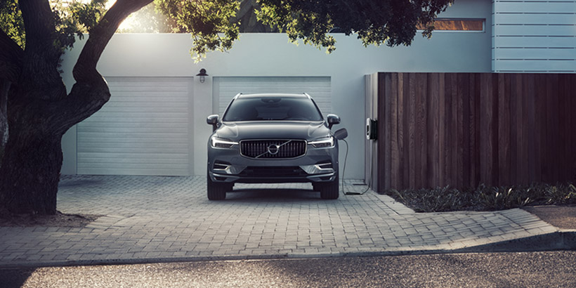 Photo of Volvo BEV charging in front of garage